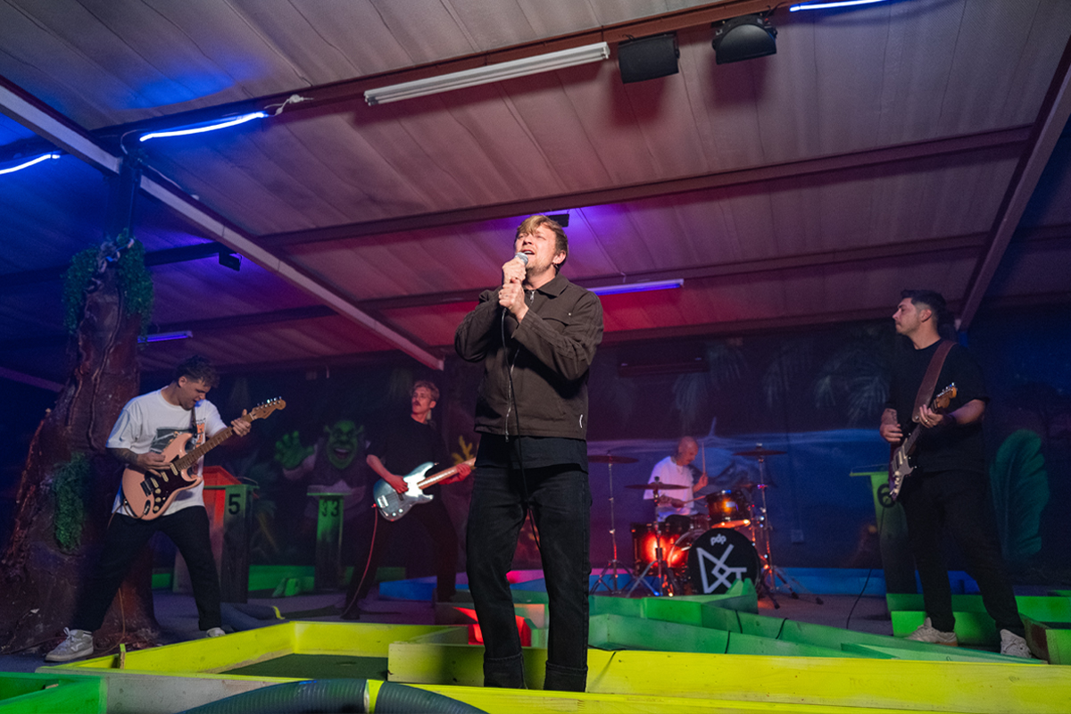 Francois van Coke and Die Gevaar performing on stage under colourful Nanlite lighting